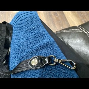 Black patten  leather Sondra Roberts mini cross bag with strap.